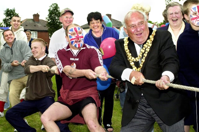 The Mayor of Wigan, Coun. Geoff Roberts, joins in the tug of war at the Worsley Hall Tennants and Residents Association Queens Golden Jubilee party on Tuesday 4th of June 2002.