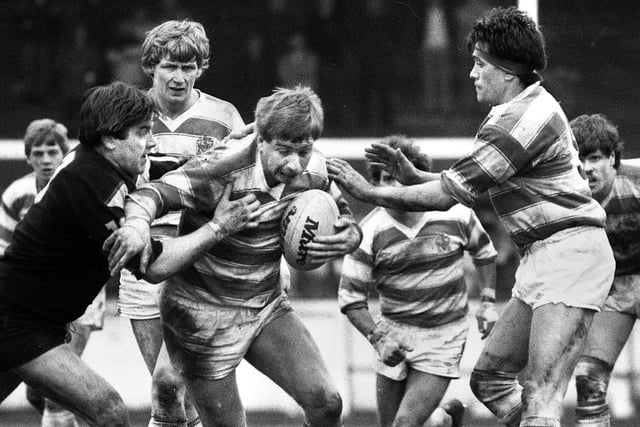 Wigan forward Mick Scott looks for a gap with Dennis Ramsdale and Howie Tamati in close support against Fulham in a league match at Central Park on Sunday 18th of March 1984. Wigan won the match 38-18.
