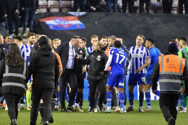 Shaun Maloney gets in between Latics winger Martial Godo and Bolton boss Ian Evatt after the derby earlier this month