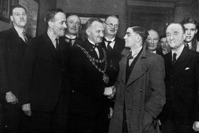 Boxer Peter Kane is greeted by the mayor during a visit to Wigan town hall. The Golborne fighter was World Flyweight Boxing Champion from 1938 to 1943 and won 127 of his 137 fights. He died in 1991.