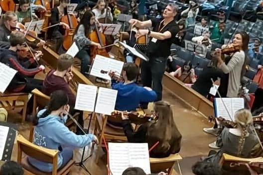 Megan Chadderton (bottom left in powder blue top) and Nicola Benedetti (top right) during the string orchestra masterclass at Bolton