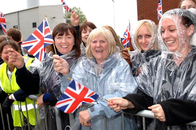 Crowds wait in the rain for the Queen and Prince Philip to arrive at Heinz.