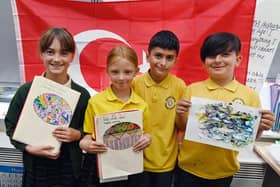 Pupils show off their artwork.