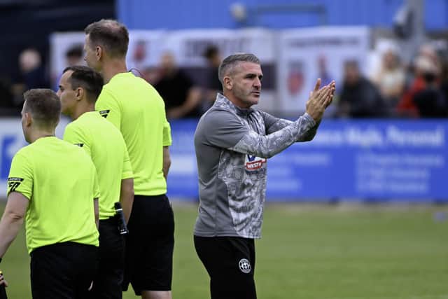 Ryan Lowe applauds the Latics fans at Chorley