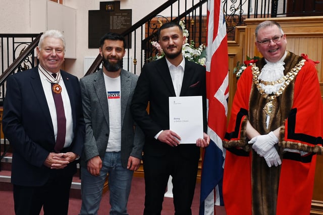 Greater Manchester Deputy Lieutenant Martin Ainscough, left,  and Mayor of Wigan Coun Kevin Anderson, right,  welcomes Wigan's new British Citizens as certificates were presented at the  monthly British Citizenship ceremony held at Wigan Town Hall.