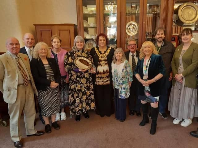 The Reverend Alison Brown and volunteers receive the Heart of the Community award from mayor Coun Debbie Parkinson and Coun Pat Draper