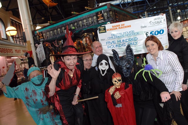 Gemma and Sophie Davies, of Scream Machine, along with Dave Clitherow, owner of the Halloween stall at Wigan Market Hall, present David Wilde, from Derian House Children's Hospice, with a donation of £500.  With them are market workers Stacey Price, left, Denise Johnson, Charlotte Taylor and Bronwen Roberts.