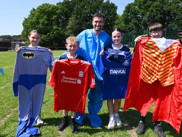 The Everton FC fan said if the event raises £1,000 he will wear the rival Liverpool FC football shirt for the last lap.