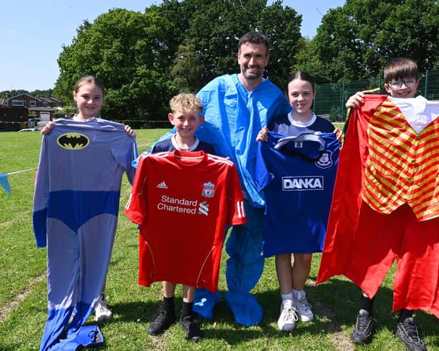 The Everton FC fan said if the event raises £1,000 he will wear the rival Liverpool FC football shirt for the last lap.
