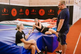 Keely Hodgkinson chats with coaches Trevor Painter and Jenny Meadows during a break from training at Robin Park