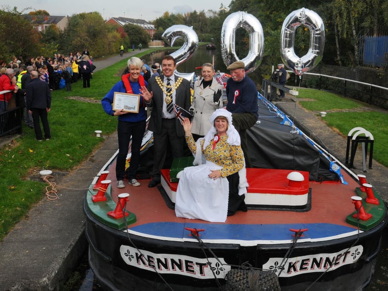 From left: Sarah Knight from Canal and River Trust, Mayor of Wigan Coun Ron Conway, Mayoress Janet Conway, Freda Childs and Lynton Childs as the historic vessel Kennet celebrated 200 years of the Leeds-Liverpool canal, recreating the inaugural voyage from 1816. It is pictured approaching Britannia Bridge, Ince, Wigan, which is dated 1816. The boat was met by members of the community and pupils from Britannia Primary School.