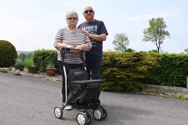 Linda and John Fowler with the trolley from which the cash was stolen while Linda was distracted