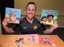 Award-winning author Alex Winstanley with his books