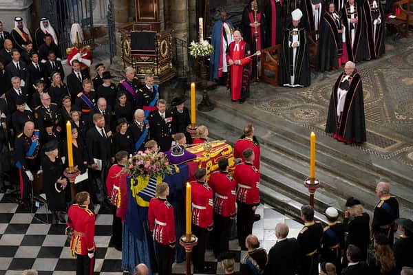 The bearer party with the coffin of Queen Elizabeth II as it is taken from Westminster Abbey
