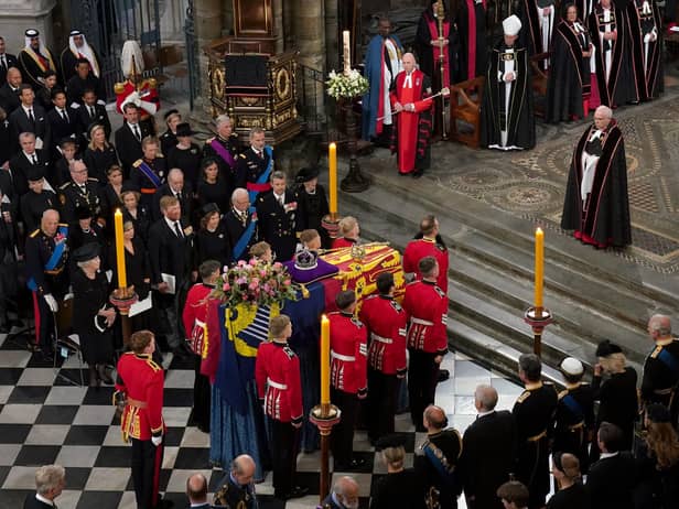 The bearer party with the coffin of Queen Elizabeth II as it is taken from Westminster Abbey