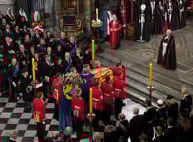 The bearer party with the coffin of Queen Elizabeth II as it is taken from Westminster Abbey