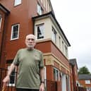 Pensioner William Barton outside his home, an assisted living complex in Hindley, where he and other residents feel trapped as the lift has been broken for weeks
