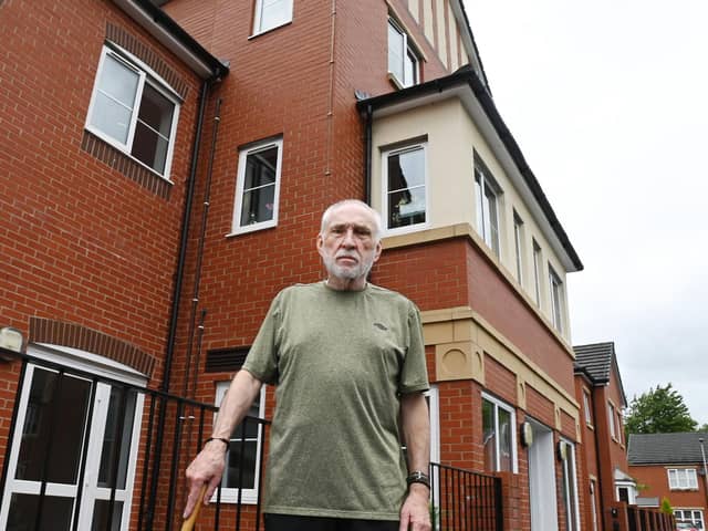 Pensioner William Barton outside his home, an assisted living complex in Hindley, where he and other residents feel trapped as the lift has been broken for weeks