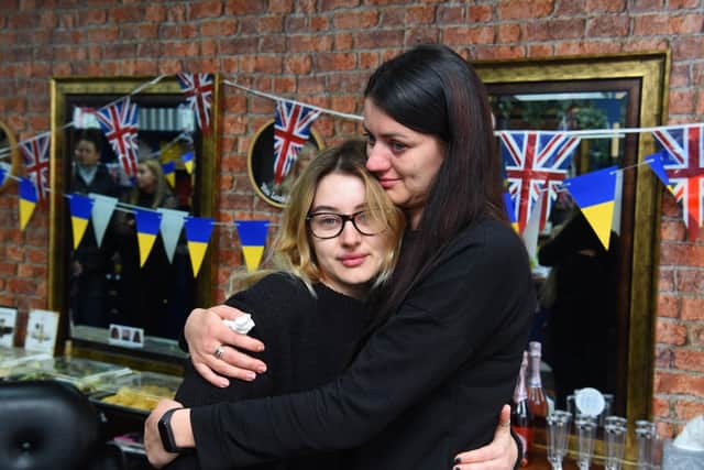 Photo Neil Cross;  Ukraine refugee and salon employee, Inna Hashynskya, is overcome with emotion, with her sister Alina Podolian