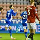 Joe Hugill celebrates opening his goalscoring account for Latics against Morecambe