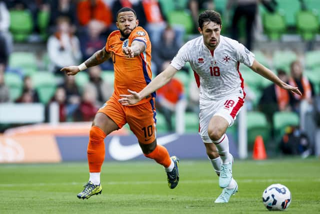 Wigan Athletic defender James Carragher (right) in action for Malta against the Netherlands in 2025