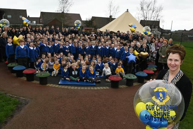 Headteacher Mel Smith, right, celebrates with staff and pupils at St Marie's Catholic Primary School, Standish