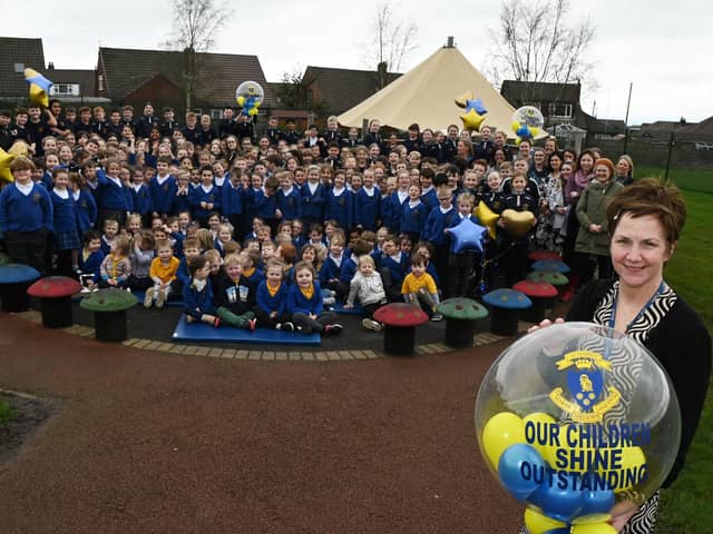 Headteacher Mel Smith, right, celebrates with staff and pupils at St Marie's Catholic Primary School, Standish