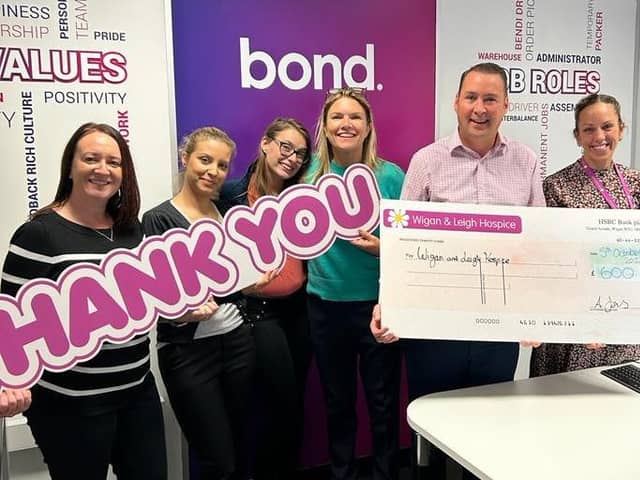 Staff at Bond Personnel hand over a cheque to representatives from Wigan and Leigh Hospice