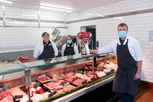 David Green at the Standish shop, joined by manager Jeanette Chadwick, left, and Louise Saile with a trophy awarded to a supreme cattle champion and a prime cut from it