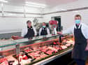 David Green at the Standish shop, joined by manager Jeanette Chadwick, left, and Louise Saile with a trophy awarded to a supreme cattle champion and a prime cut from it