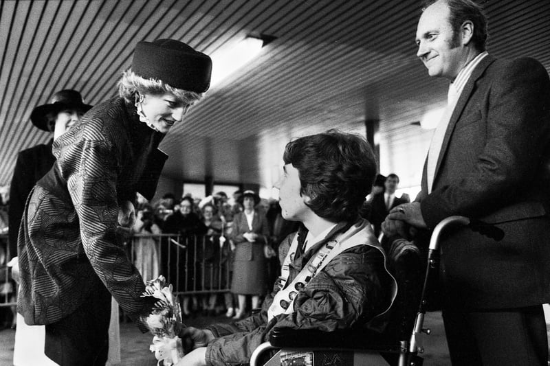 Princess Diana accepts a posy of flowers from Stephen Hooton of Orrell watched by proud dad Jim at Wigan North Western station as she and Prince Charles made their way to open a factory in Skelmersdale on Wednesday 23rd of April 1986.