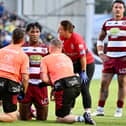 Junior Nsemba is assisted by the Wigan Warriors medical staff during their win over Warrington Wolves