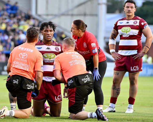Junior Nsemba is assisted by the Wigan Warriors medical staff during their win over Warrington Wolves