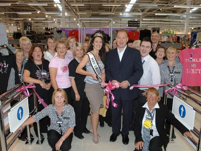Wigan Warriors rugby executive Dean Bell and Mrs England, Jayne Taylor, dressed in George, from Wigan, open the new George department at Asda, Newtown, watched by staff.