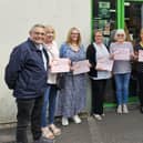 Coun Chris Ready, far left, presents Heart of the Community certificates to staff and volunteers at the Barnardo's shop in Aspull