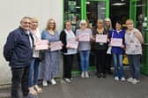 Coun Chris Ready, far left, presents Heart of the Community certificates to staff and volunteers at the Barnardo's shop in Aspull