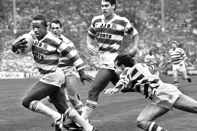 Wigan's Ellery Hanley avoids the tackle of former team-mate Gary Stephens to score a try against Halifax backed up by Andy Goodway and Kevin Iro in the Challenge Cup Final at Wembley on Saturday 29th of April 1988. Wigan won the match 32-12.