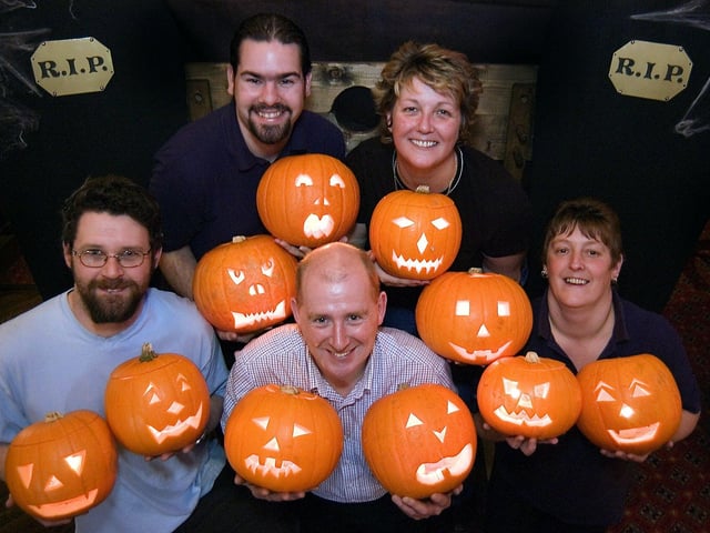 Sinister Bunch staff members Leon Cadman, Mike Taylor and Denise Kelly join Jon and Vicky Ambrose preparing for Halloween charity party night