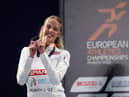Keely Hodgkinson celebrates with her gold medal