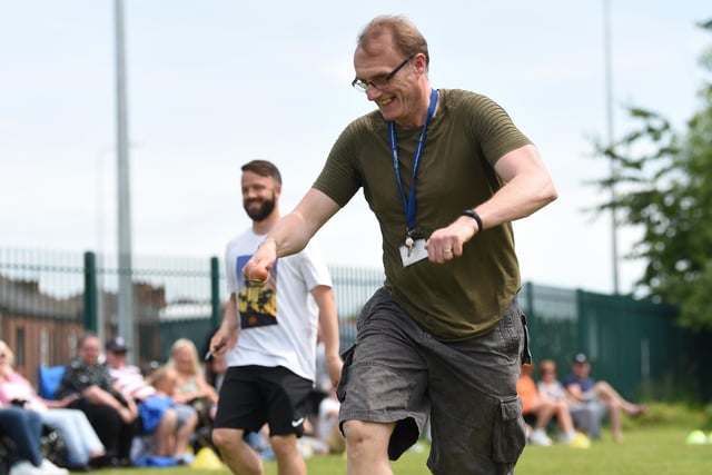 Teachers compete in the egg and spoon race.