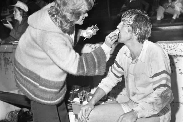 A makeup artist applies a little mud to the star's face. Television series "Fallen Hero" filmed at Central Park on Monday 31st of July 1978 starring Del Henney as Gareth Hopkins a Welsh rugby union player who turns down the chance of an international cap and goes north to rugby league for cash. The script was by Wigan writer Brian Finch.