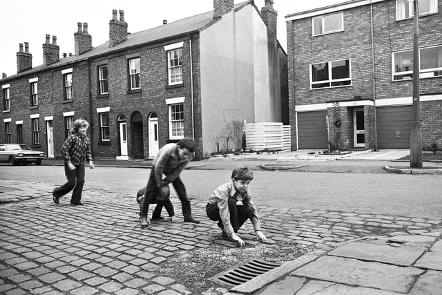 A game of leapfrog for lads in Duke Street, Swinley, in January 1975.