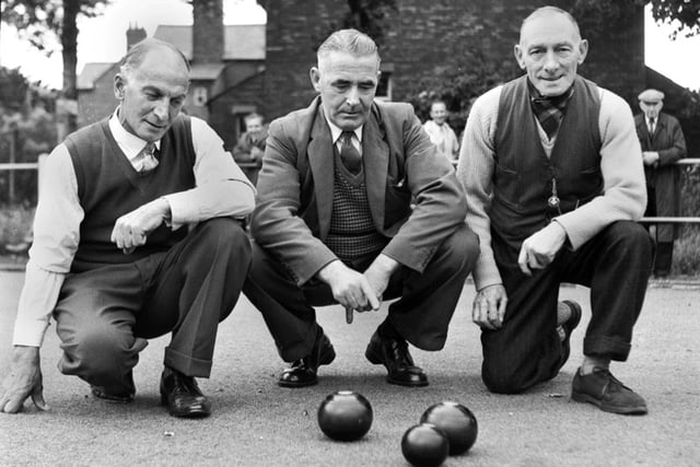 Some gentleman bowlers study the woods on a Wigan green in the 1960s.