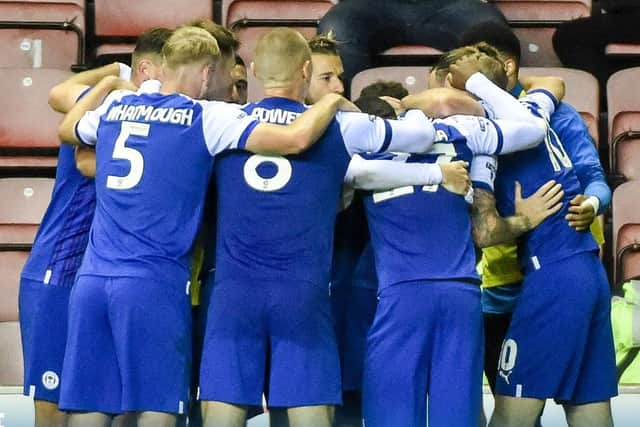 The Latics players celebrate victory over Blackburn