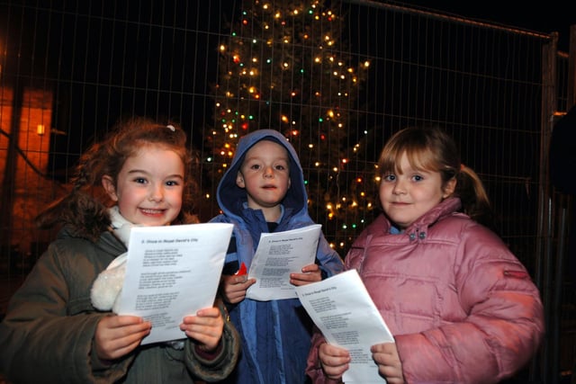 Excited youngsters greet join the carol singing at the Golborne Christmas lights switch on, ltr Morgan Griffiths, Lewis Aston and Sophie Pye, .