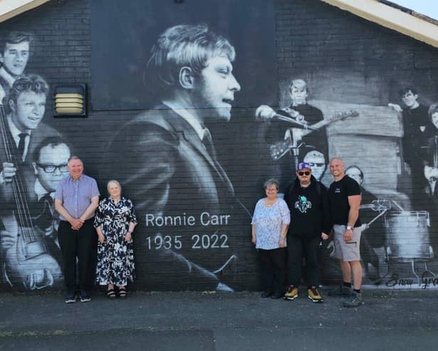 A mural to musician Ronnie Carr, who played bass guitar with 'The Beat Boys' a Leigh-based rock n’ roll, pop and skiffle band popular with audiences during the 1960s, has been created at the side of The Gary Kay Centre, Spinning Gate, Leigh, by Wigan-based artist Scott Wilcock, AKA Snow Graffiti