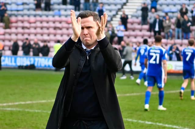 Gary Caldwell applauds the Wigan Athletic fans at the Brick Community Stadium