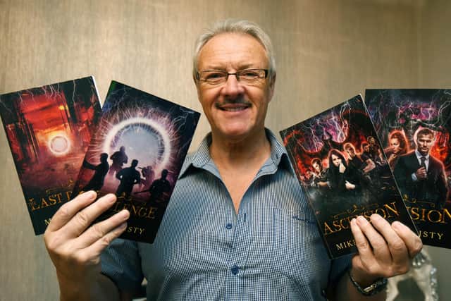 Wigan author Mike Christy with his four supernatural novels.
