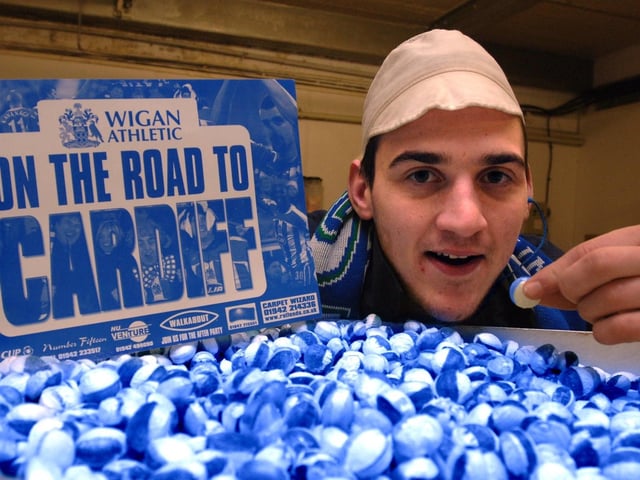 Adam Bentley of Uncle Joe's Mint Balls pictured with the special blue and white 'Latics' mint to show support with Wigan Athletic FC