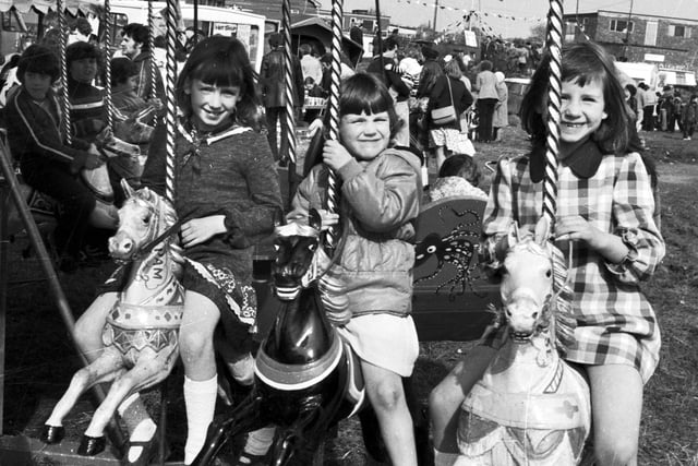 Young friends enjoying a roundabout ride at the Easter boat rally at Appley Bridge in 1979.